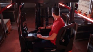 Operator seated in the ergonomic workspace of the Linde MH reach truck Ri16.