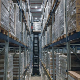 A K-MATIC automated very narrow aisle truck from Linde MH stores a pallet.
